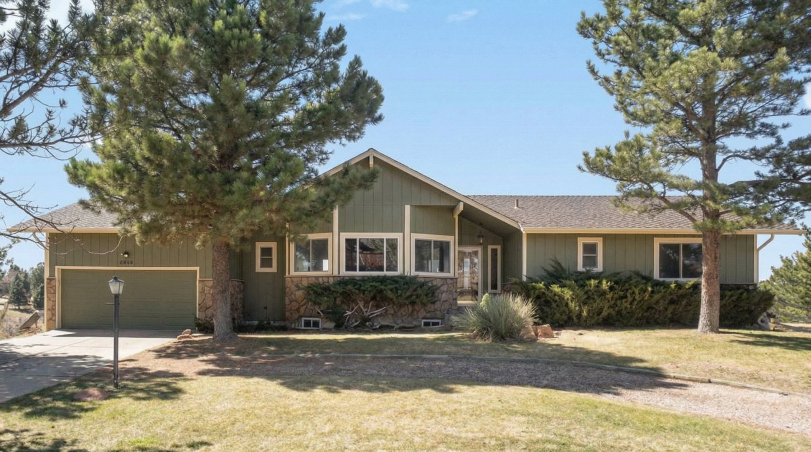 Spacious green-colored family home with front porch