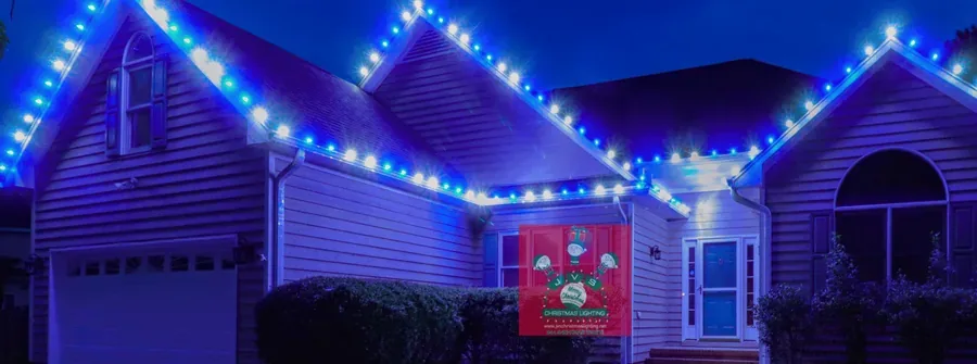 Home lit in blue & cool white Christmas lights