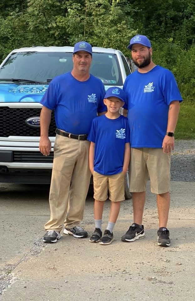 Three members of the Super Soakers family team in matching blue shirts