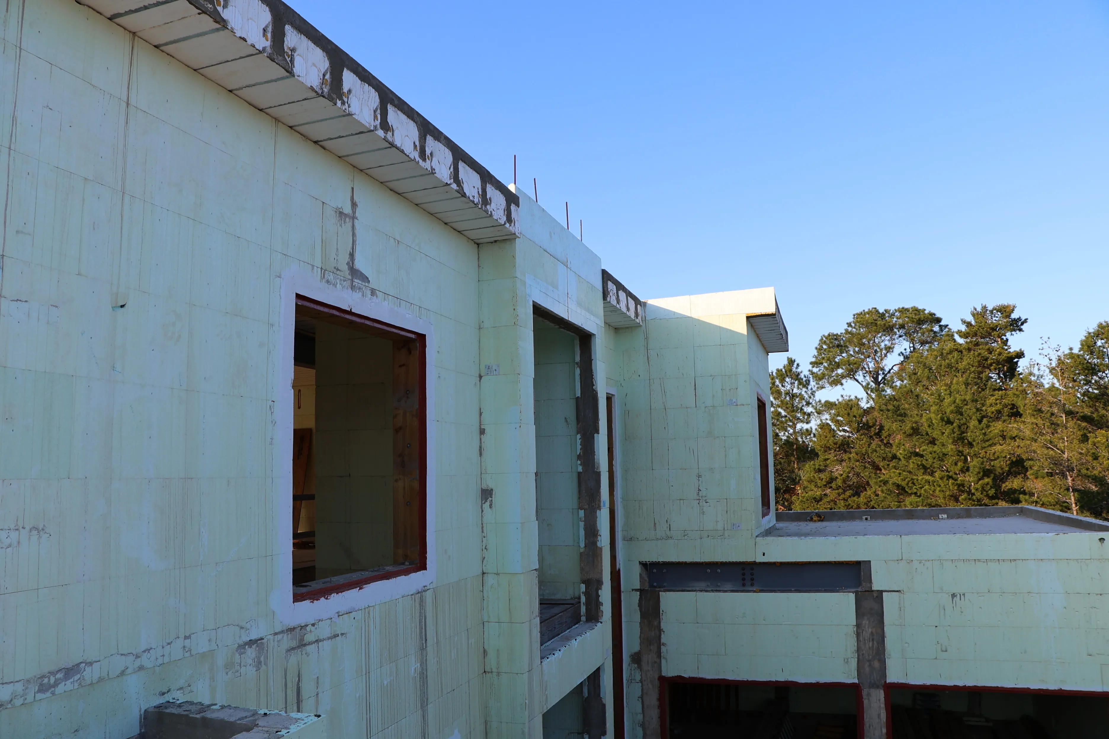 An insulated concrete form wall with a large square window opening framed through it.
