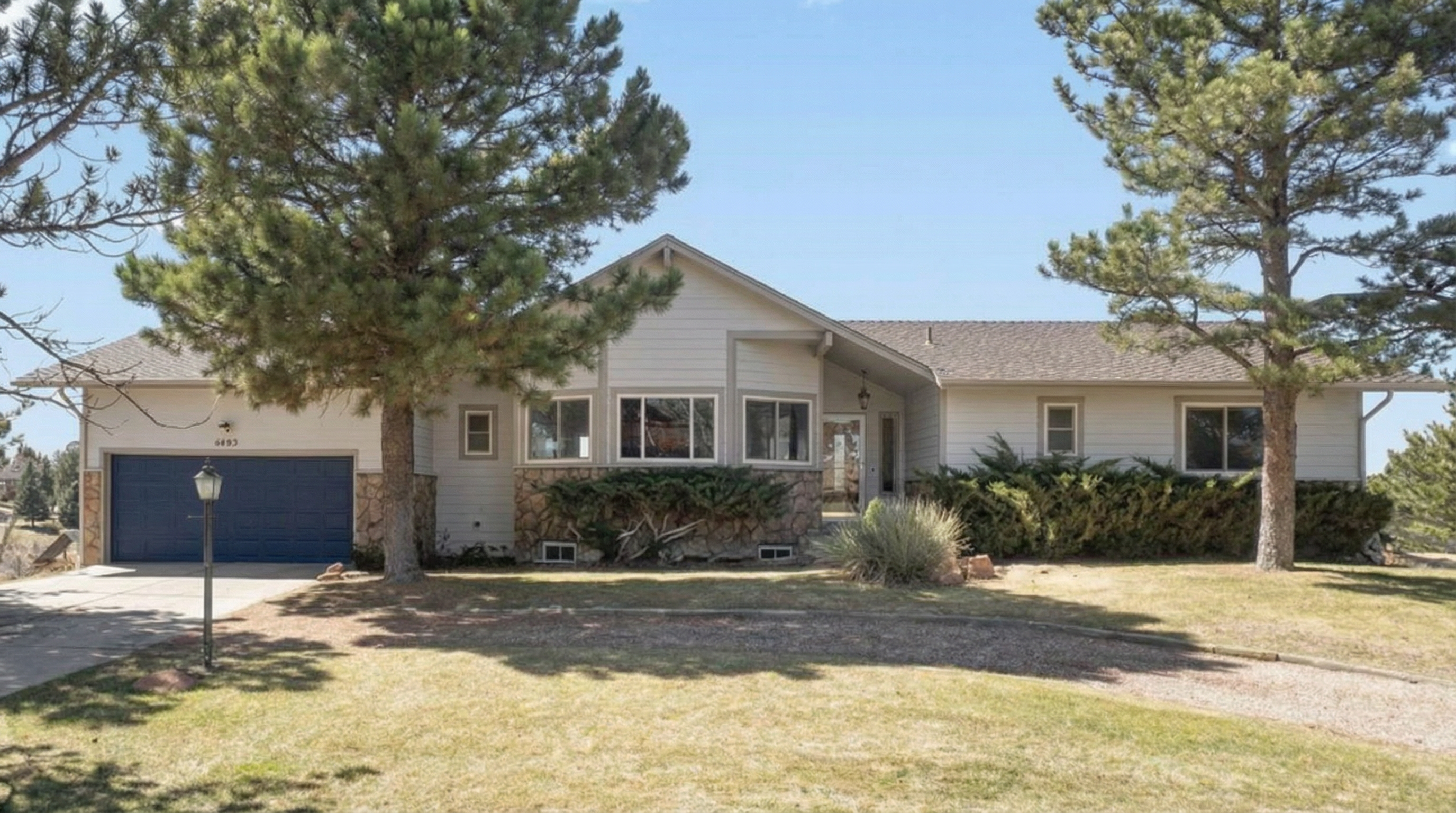 Modern single-family home with light exterior and stone accents