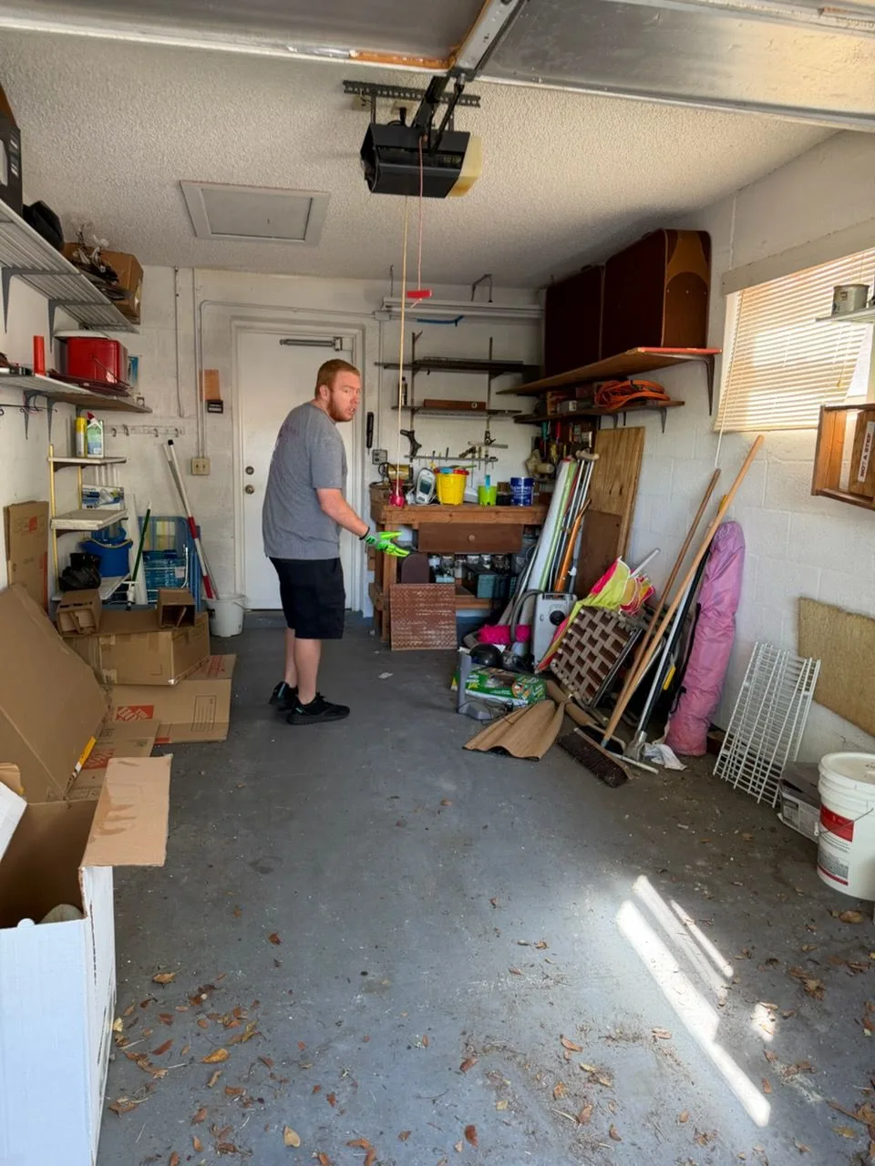 A packed Boca Raton garage before Dump Wizard, dissolving into the same garage empty and swept