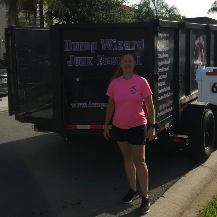 Samantha in front of the Dump Wizard trailer at a Lake Worth junk removal job