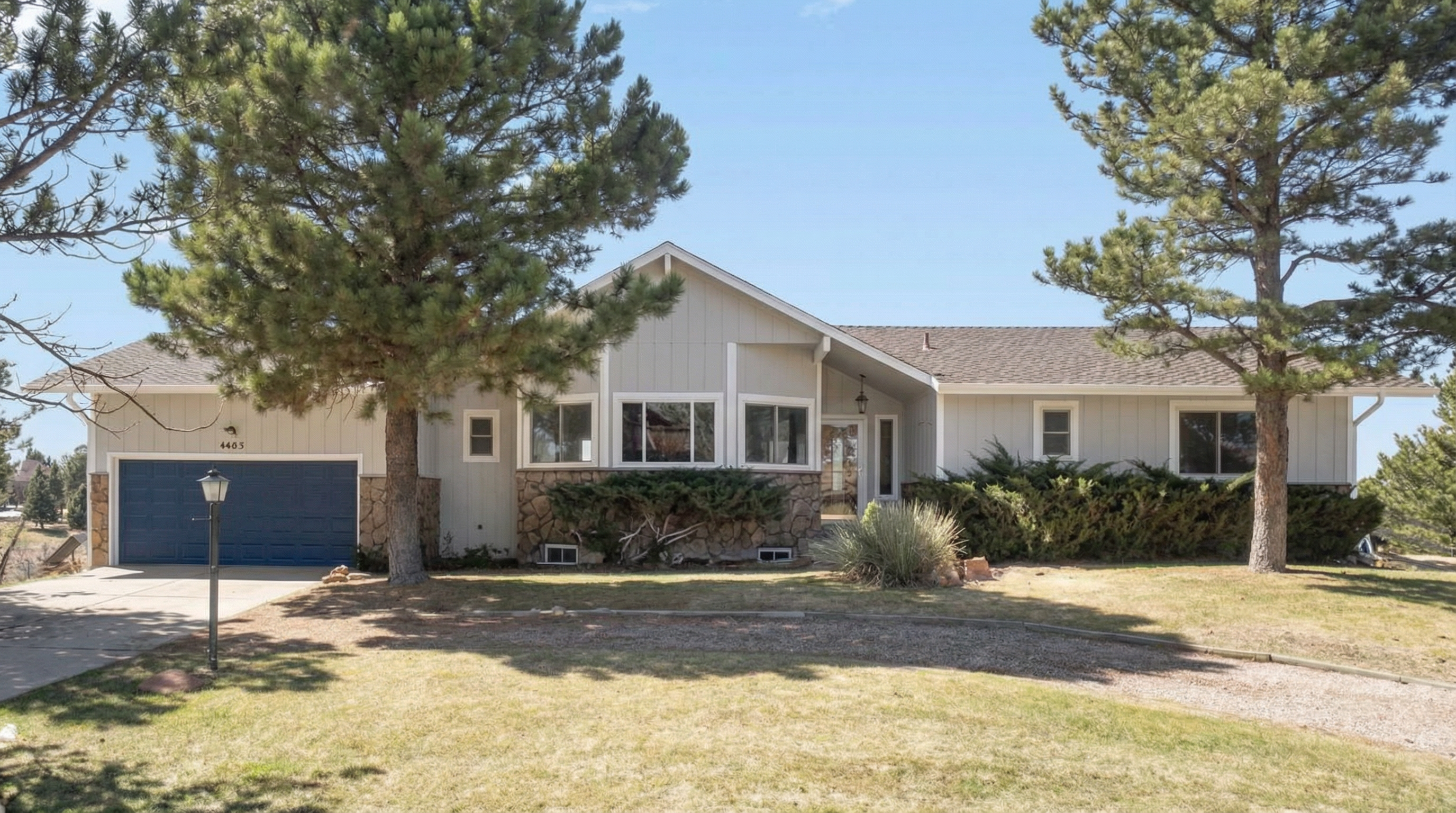 Contemporary home with light gray exterior and blue garage door