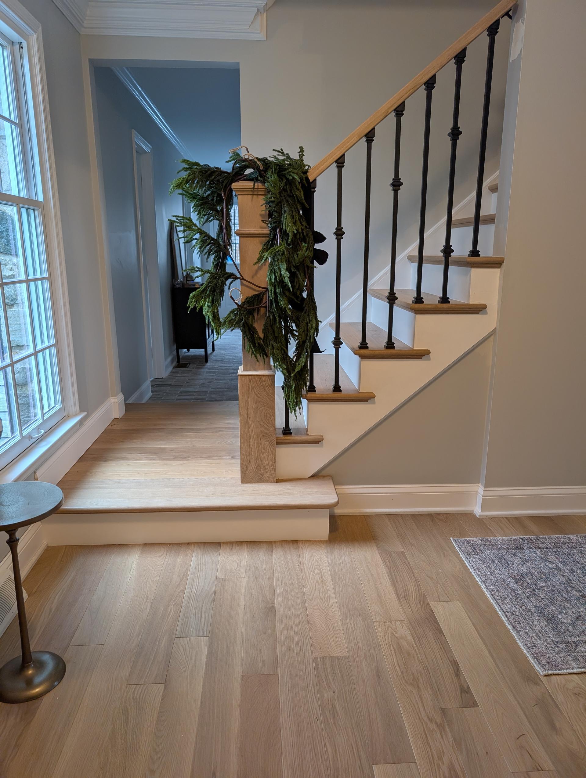 Home entryway with wooden staircase and hardwood floors