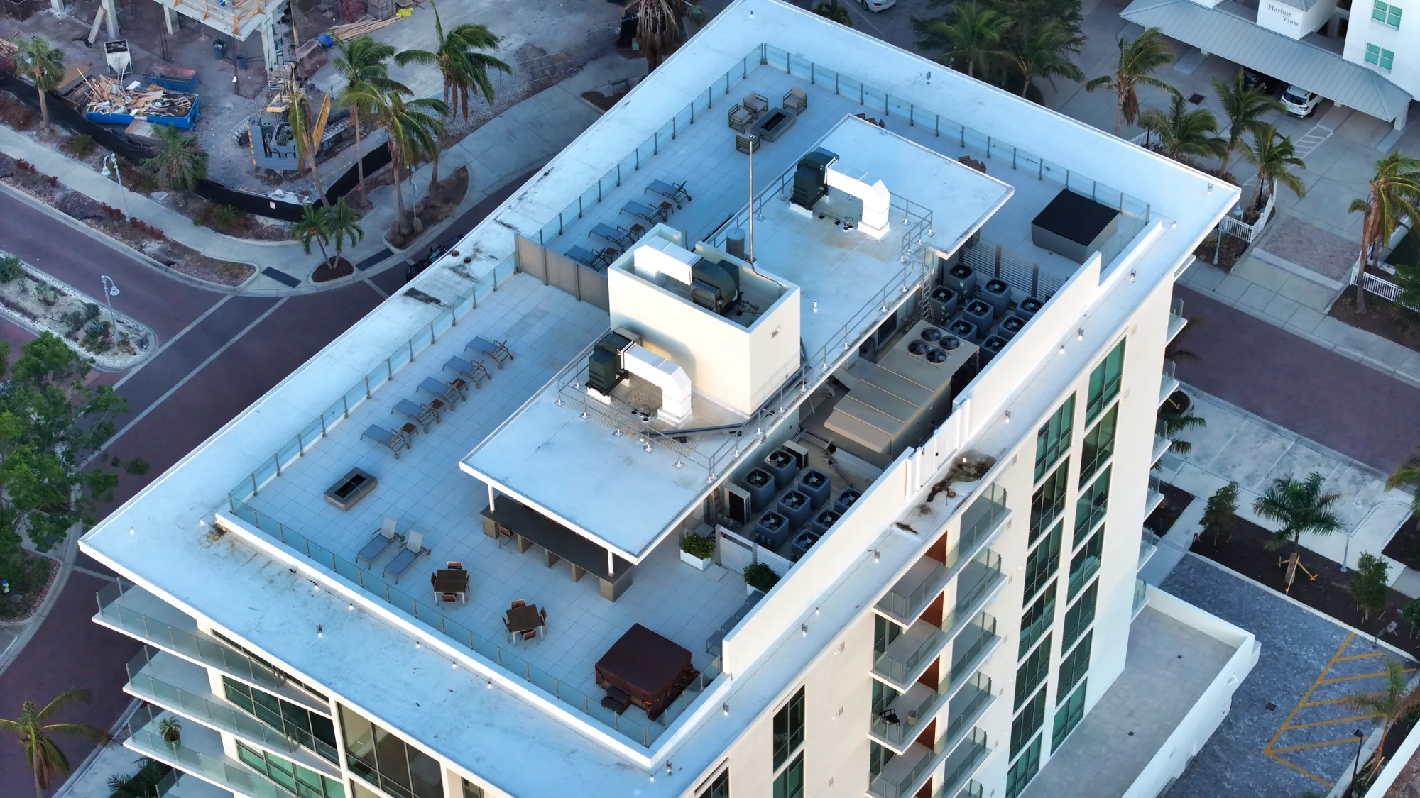 Overhead aerial of The Evolution showing its rooftop mechanical equipment and the pool deck below.
