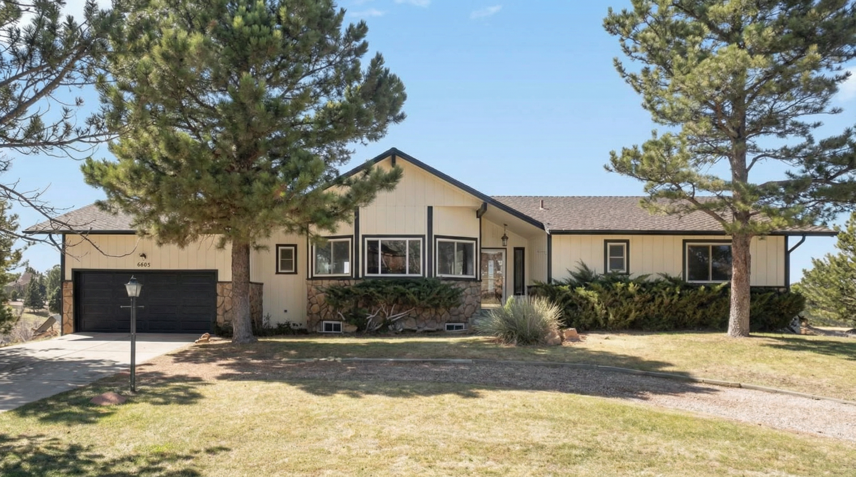 Single-story house with beige exterior and stone accent
