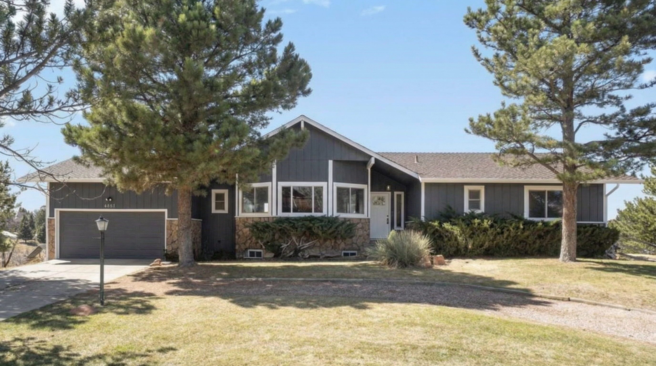 Contemporary home with grey exterior and landscaped front yard
