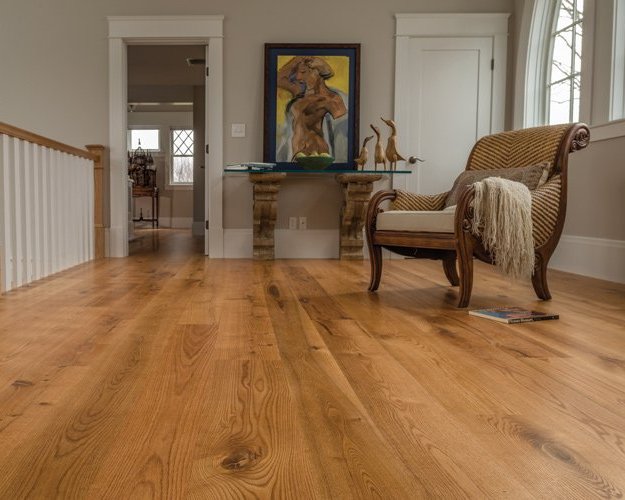 Living room with warm-toned hardwood flooring