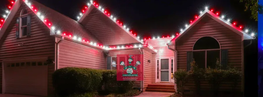 Home lit in red & cool white Christmas lights