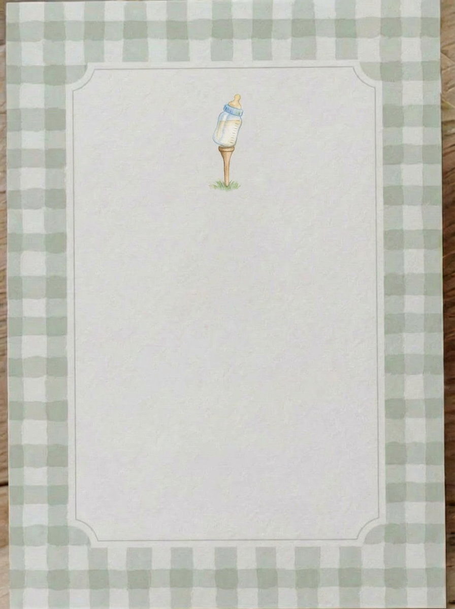 Baby bottle themed stationery with a simple illustration of a baby bottle on grass
