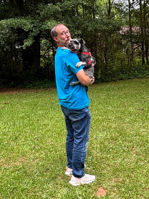 Scoop Rescue owner holding a dog outdoors in Greenville, SC