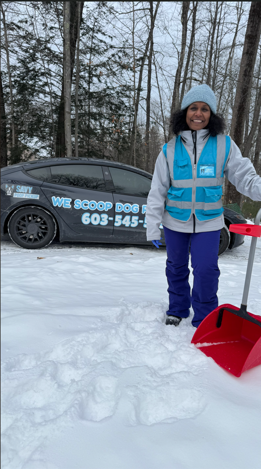 Savy Poop Pickup vehicle parked among snowy trees while a technician works with a red shovel