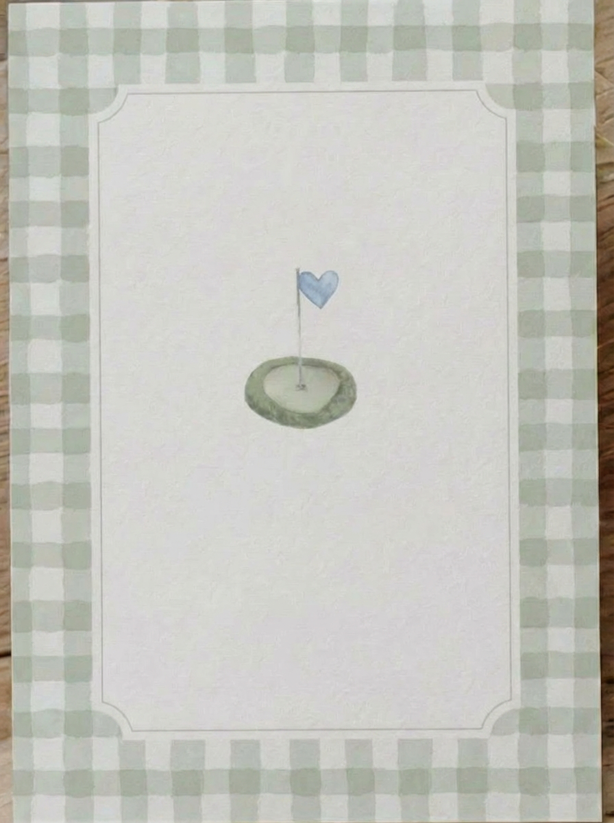 Golf flag with heart shape featuring a golf hole with a flag shaped like a heart