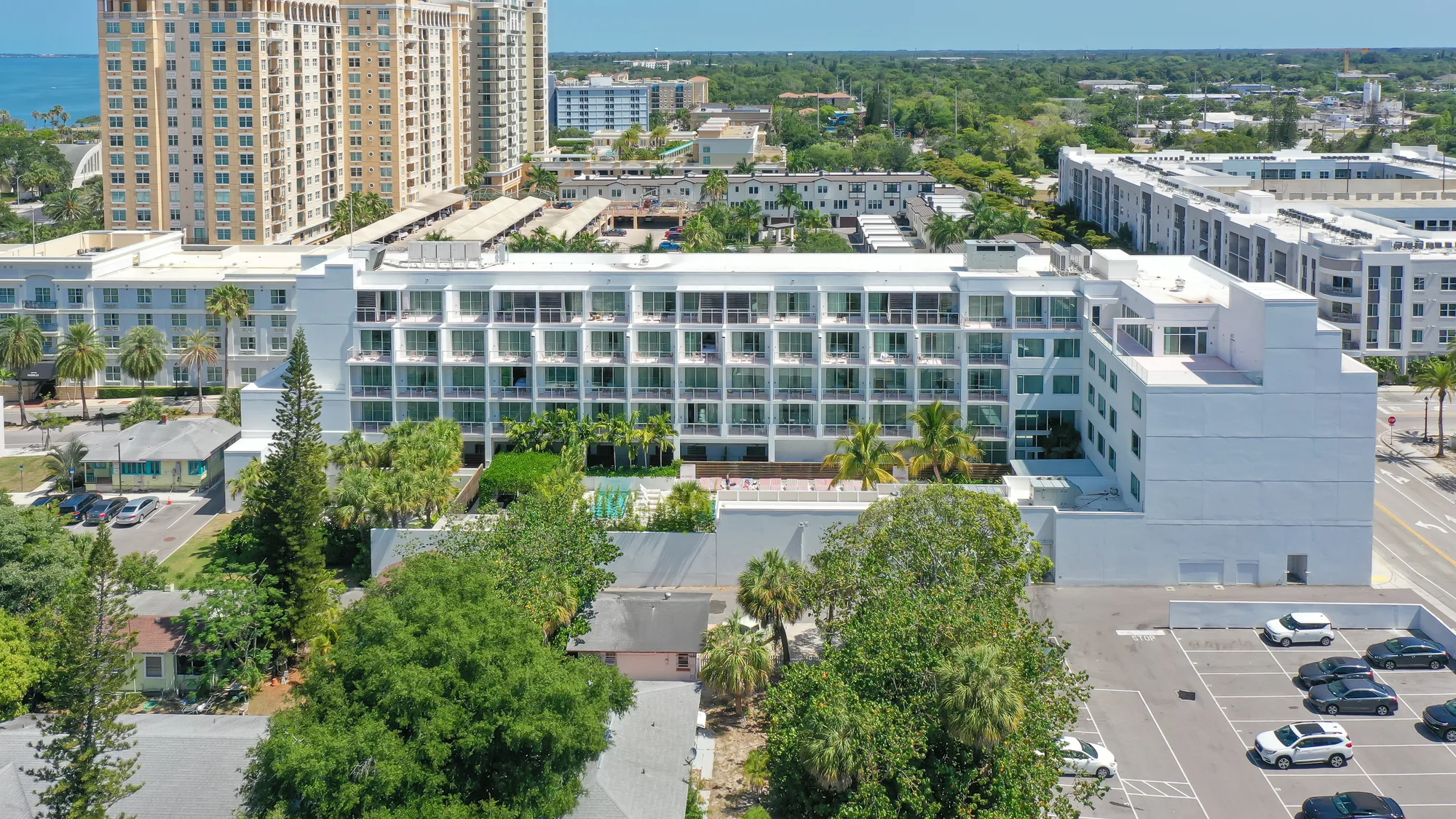 Aerial of The Sarasota Modern Hotel, a low white building set among trees in Sarasota.