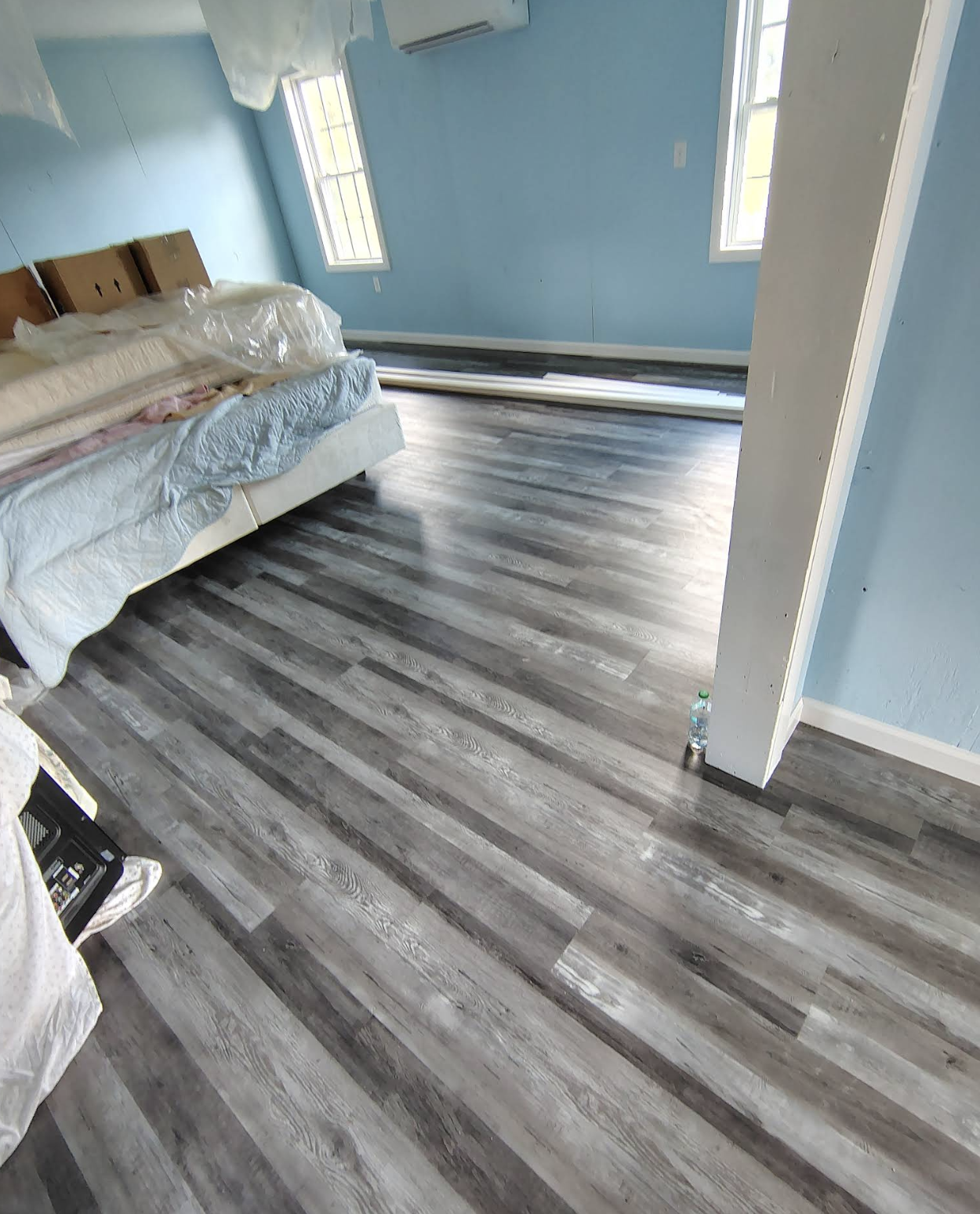 Interior room with new gray-wood laminate flooring and freshly painted walls