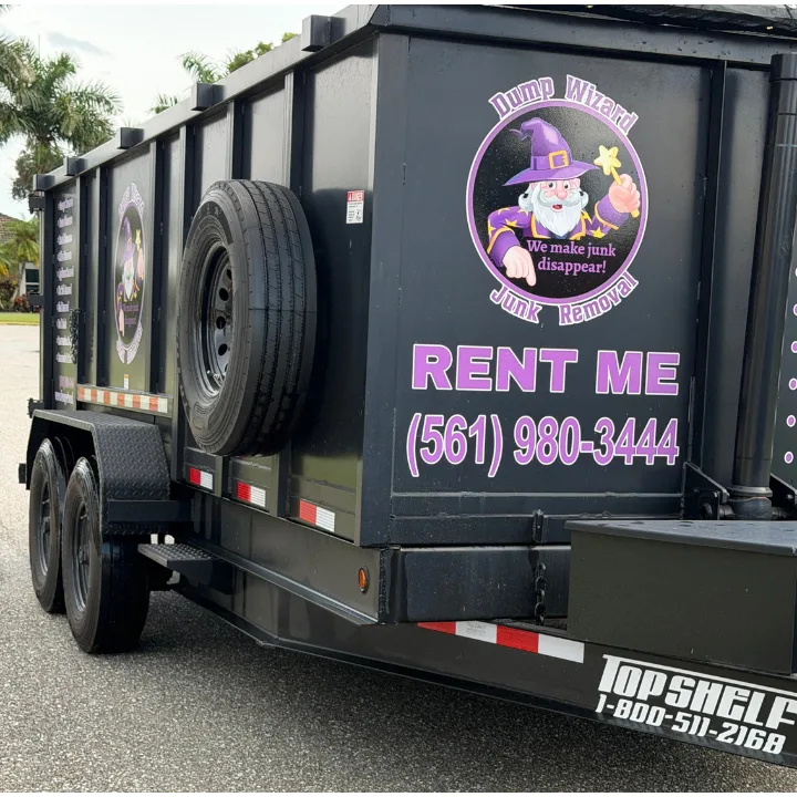Close-up of the Dump Wizard rental trailer with RENT ME lettering and booking phone number