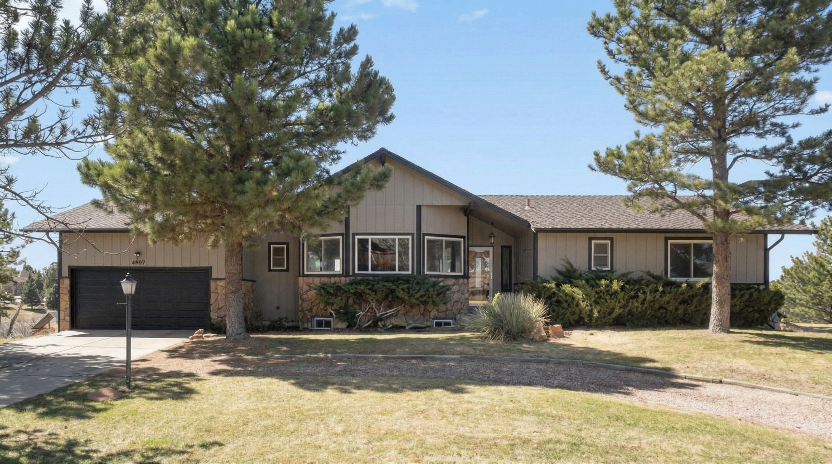 Modern residential home exterior with wood and stone