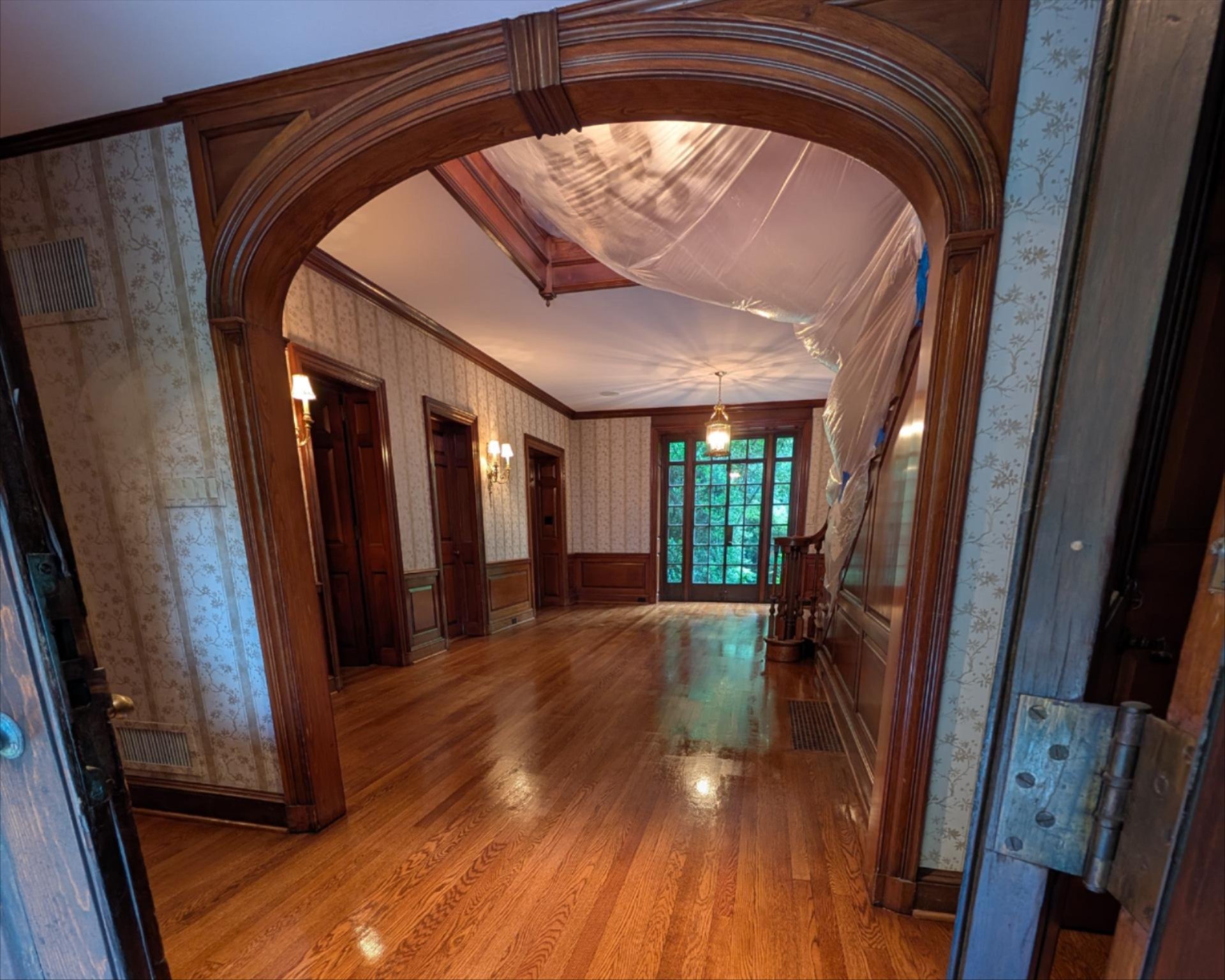 Elegant hallway with polished hardwood floors and wood paneling