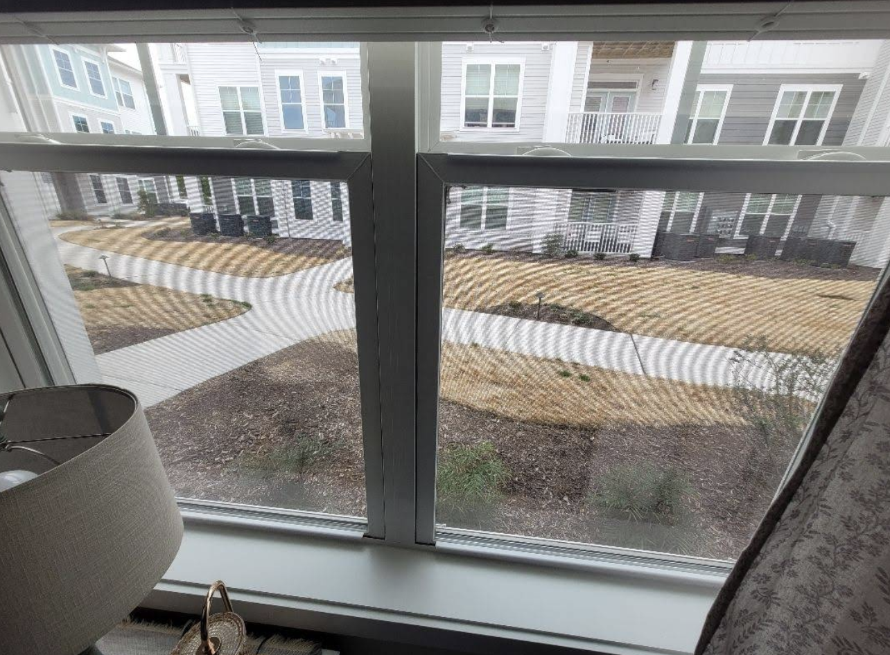 View of a landscaped apartment courtyard from an upper-floor window