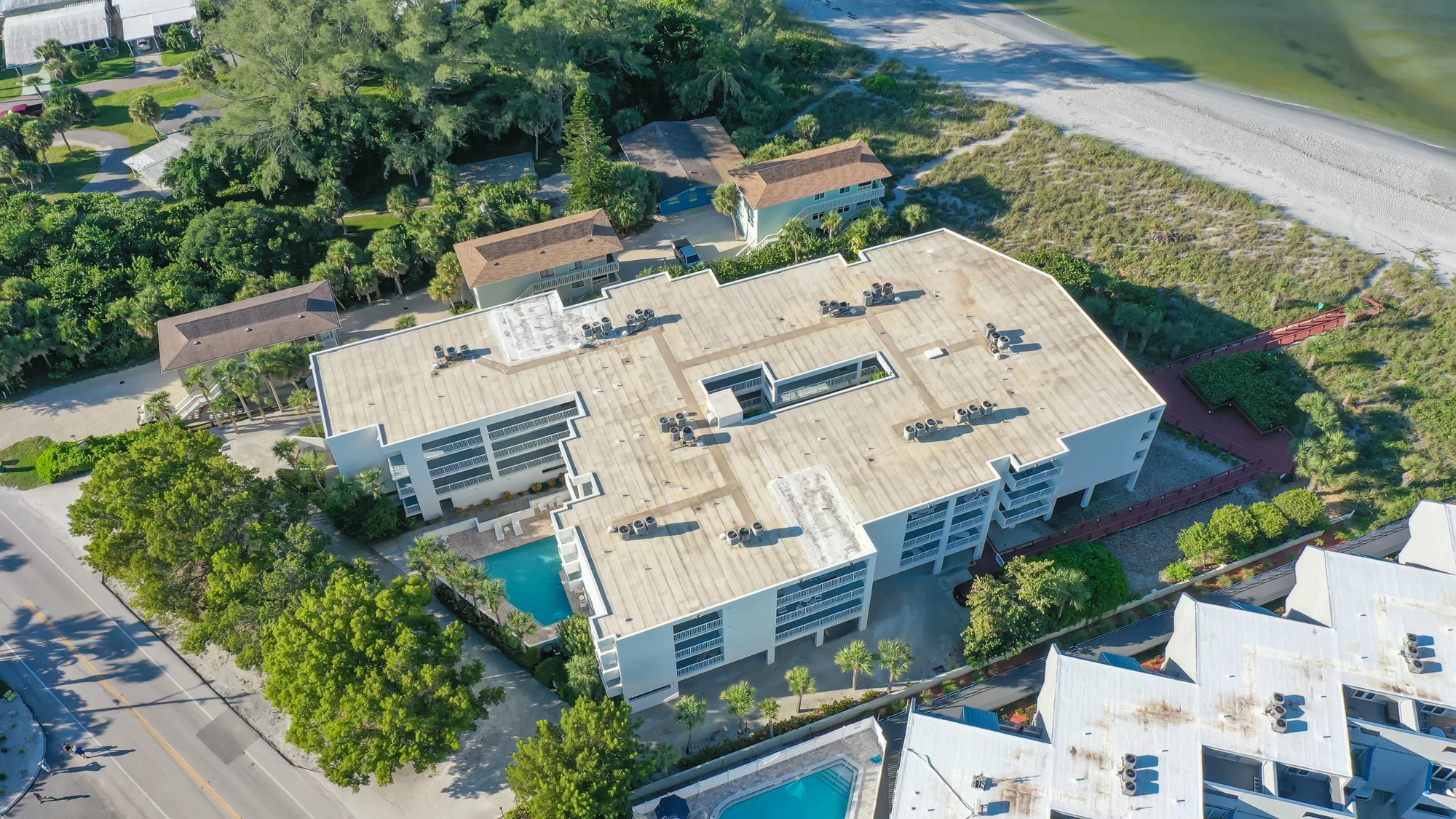 Aerial over Sarasota's bayfront showing the Six88 development, marina and turquoise water of the bay.