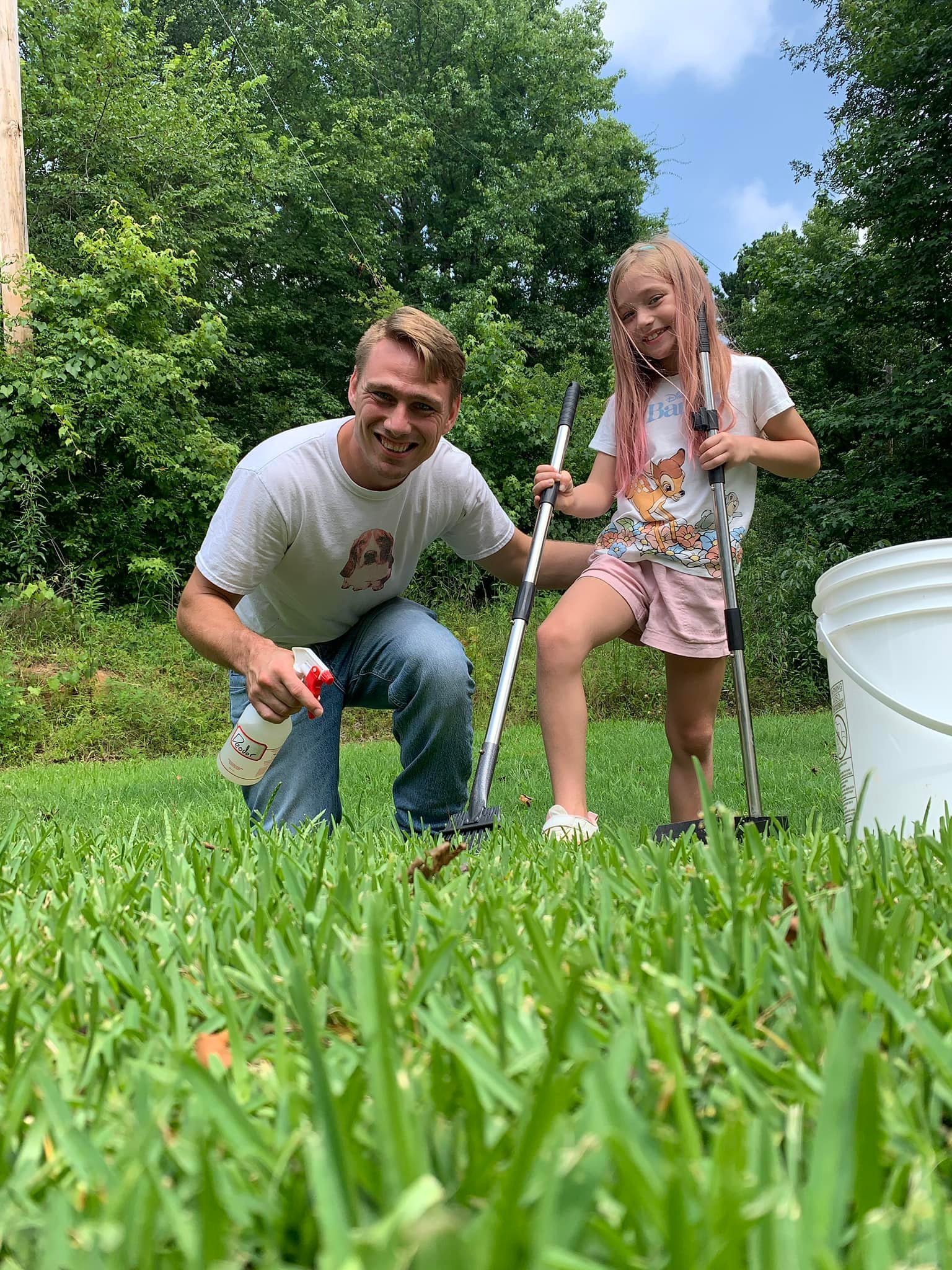 Willum, owner and founder of Doing Our Doody, gardening alongside his young daughter on a lush Texas lawn