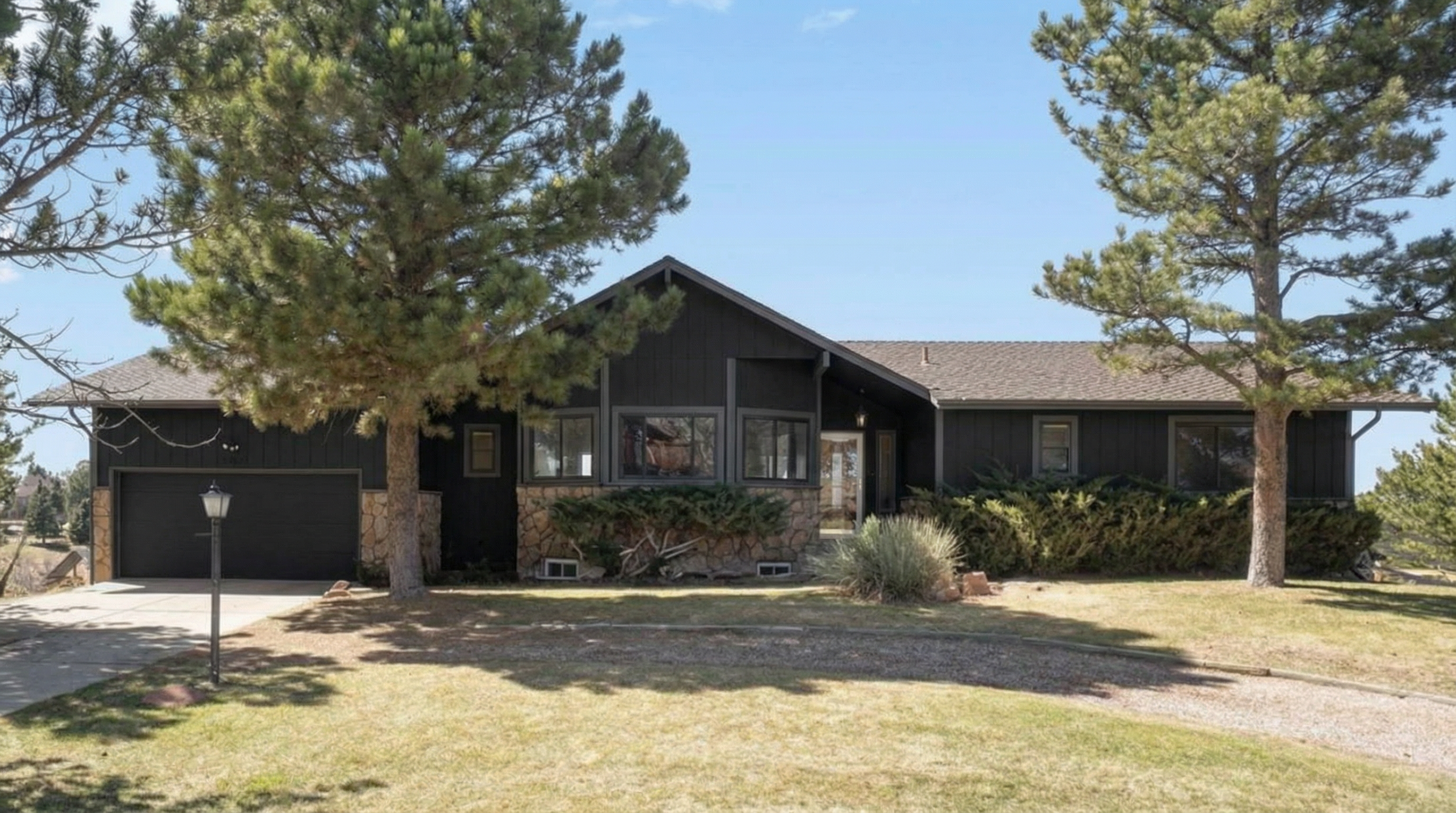 Modern home with black exterior and stone accents