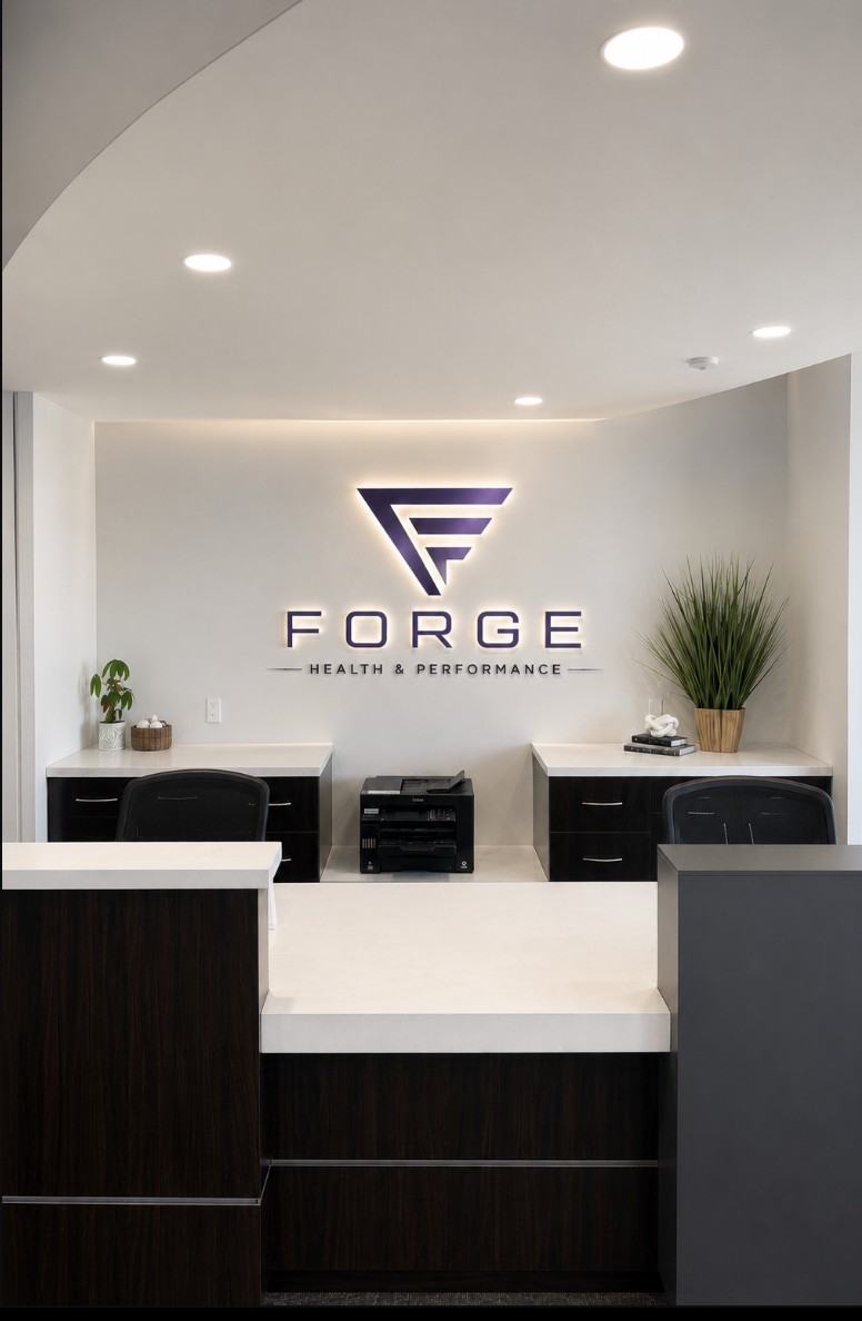 The Forge Health & Performance reception with its illuminated logo wall.