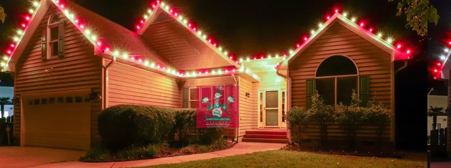 Home lit in red & warm white Christmas lights