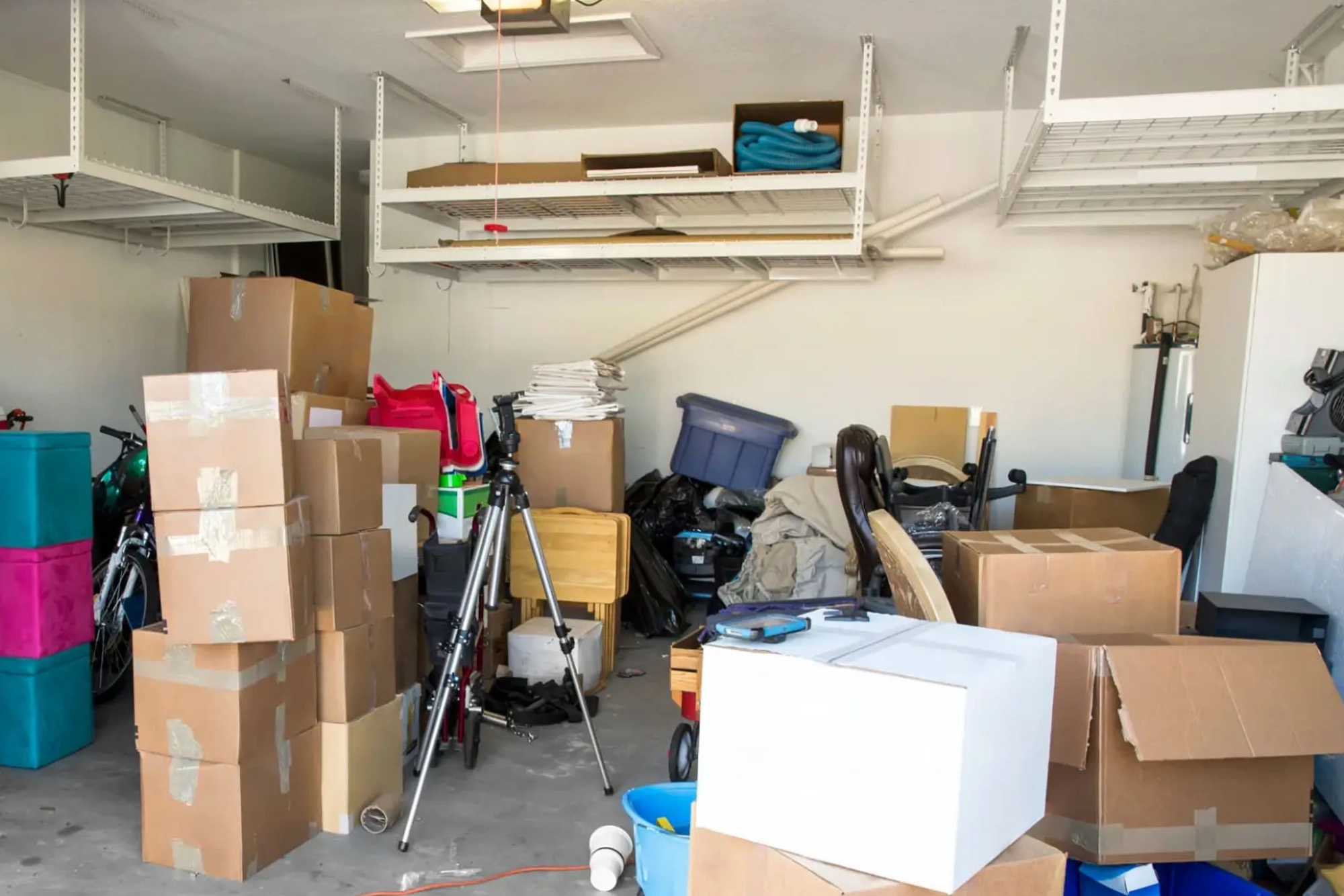 Before: cluttered garage at the start of a full cleanout