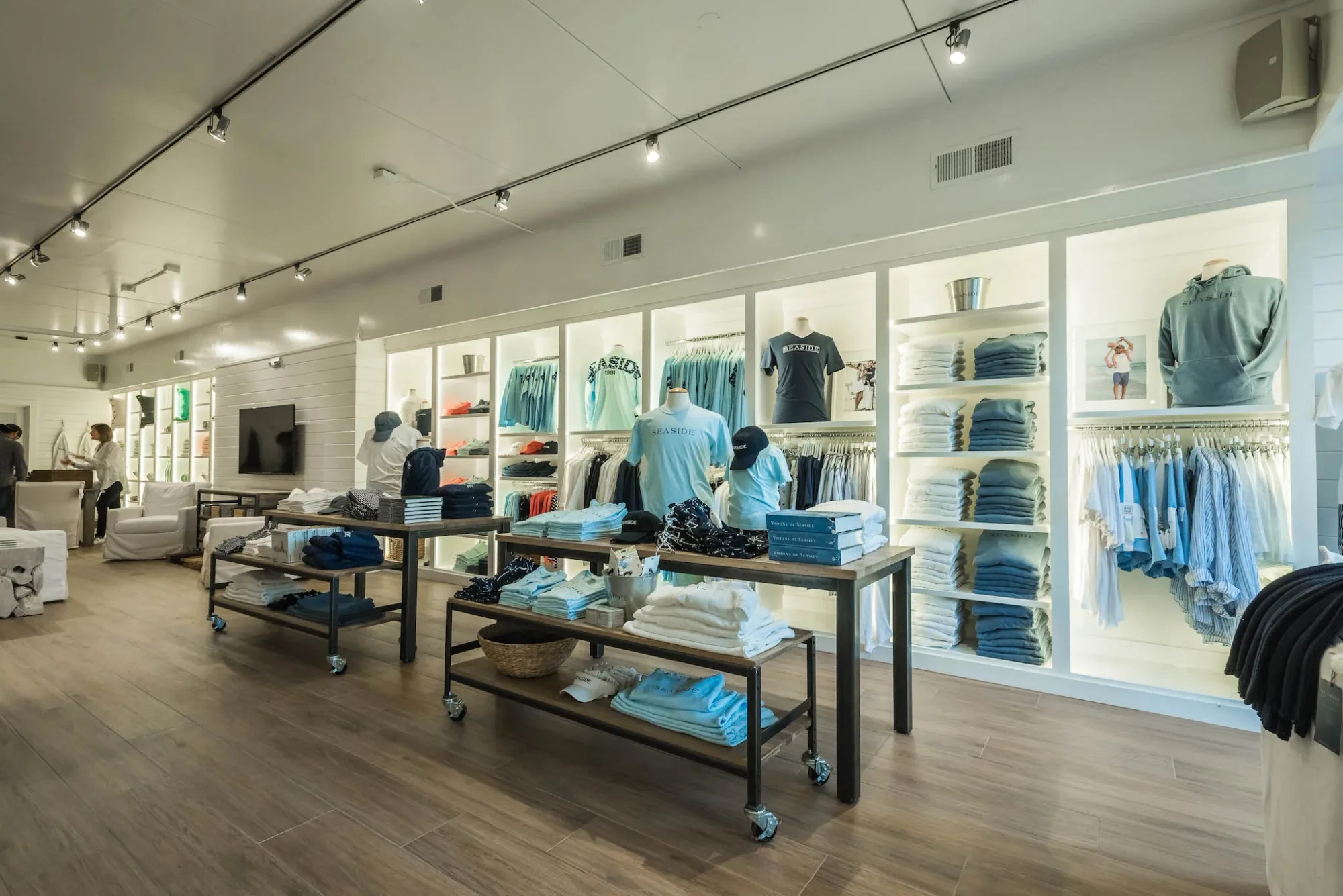 A finished retail store interior in Seaside, Florida with custom backlit display shelving.