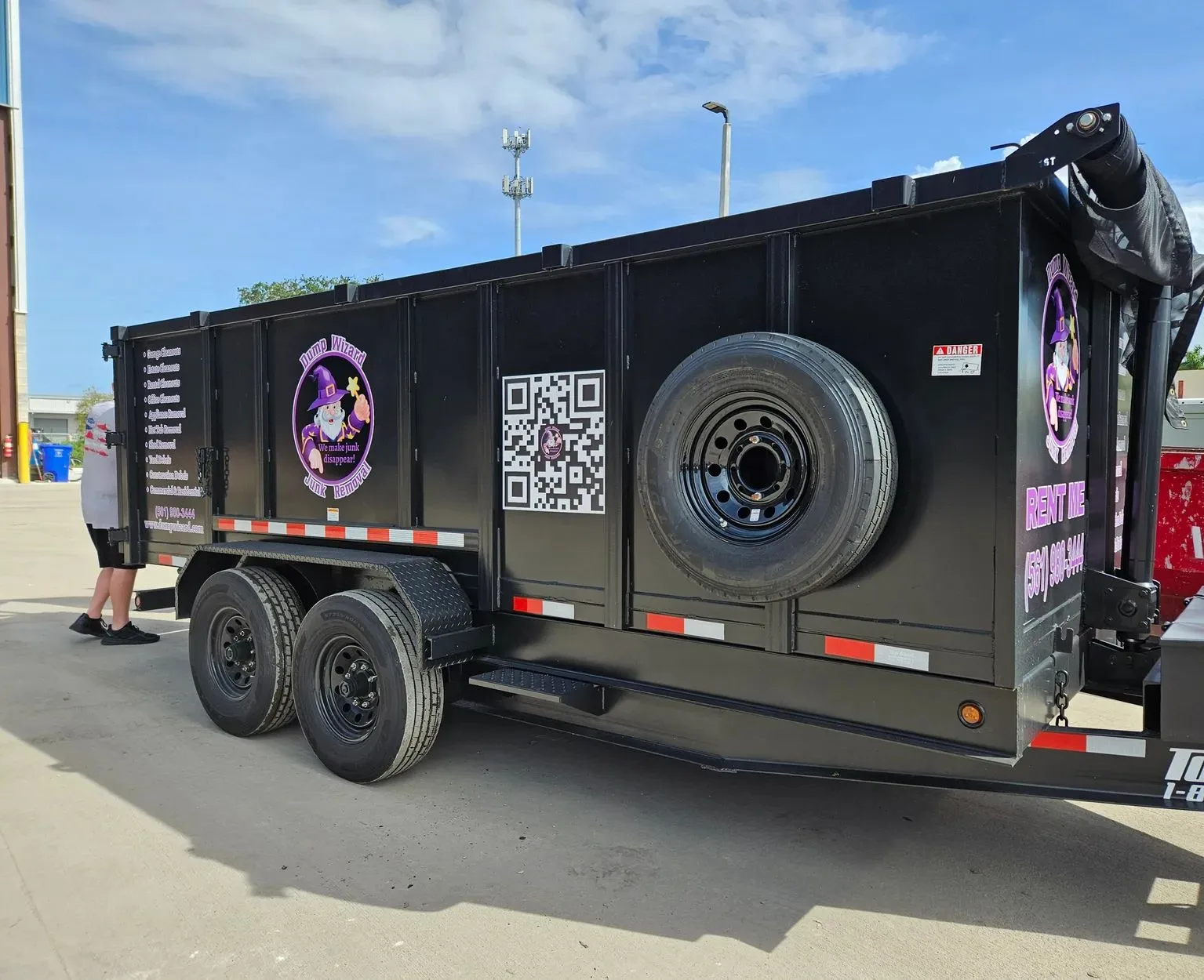 Rear of the Dump Wizard trailer with booking QR code