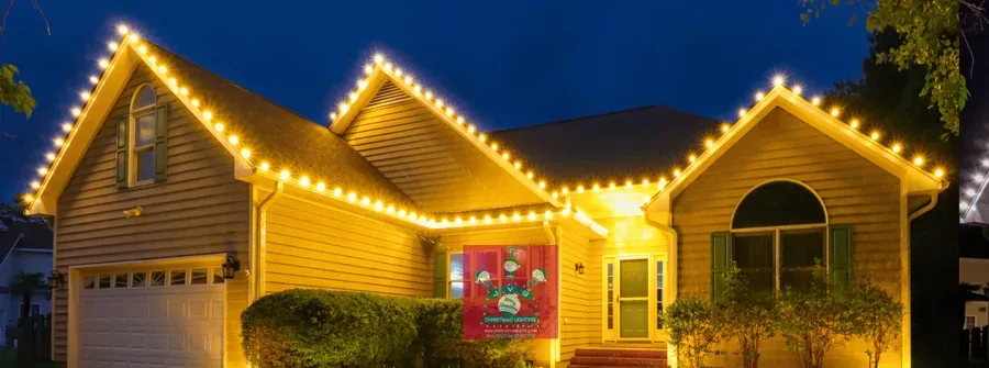 Home lit in warm white Christmas lights