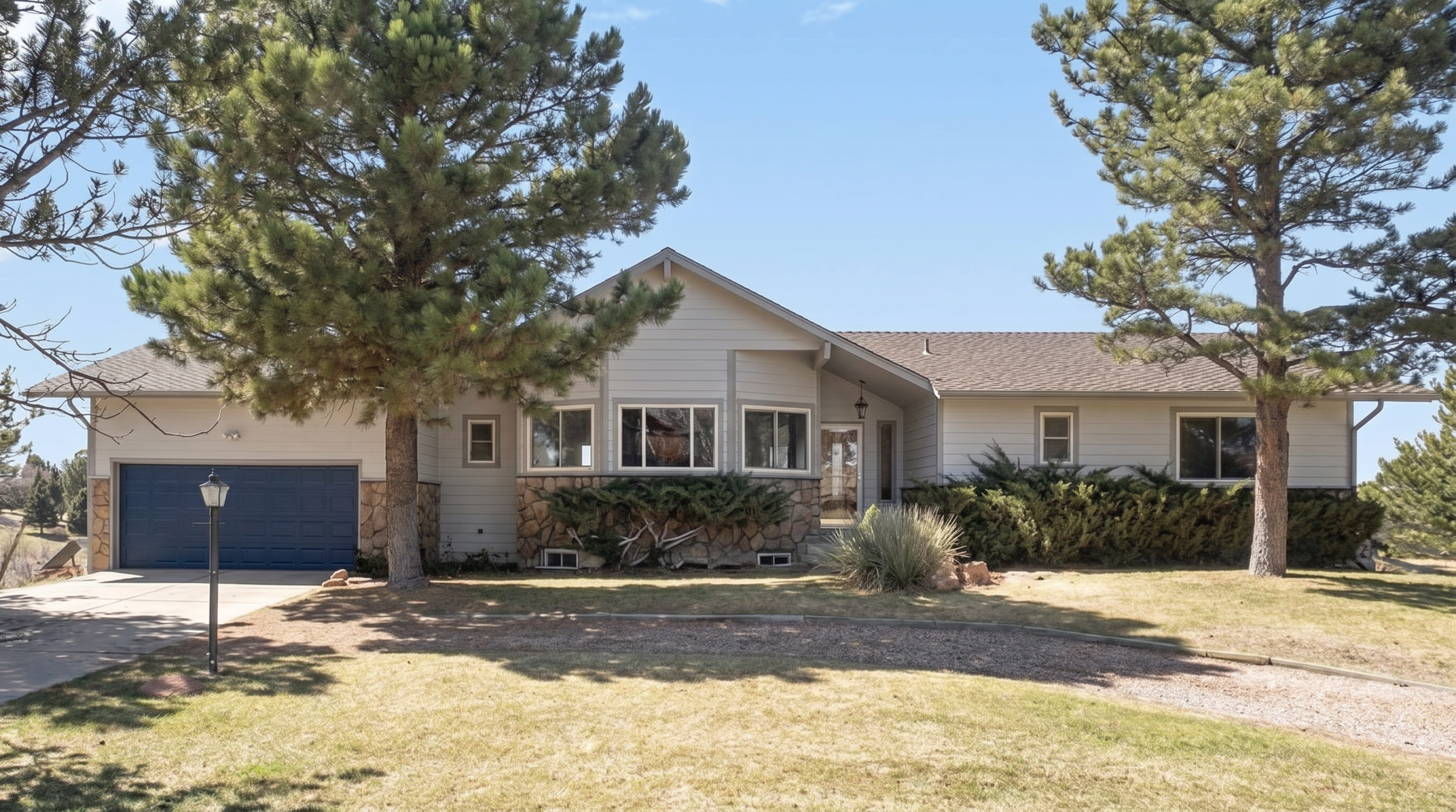 Contemporary home with stone accent facade and blue garage door