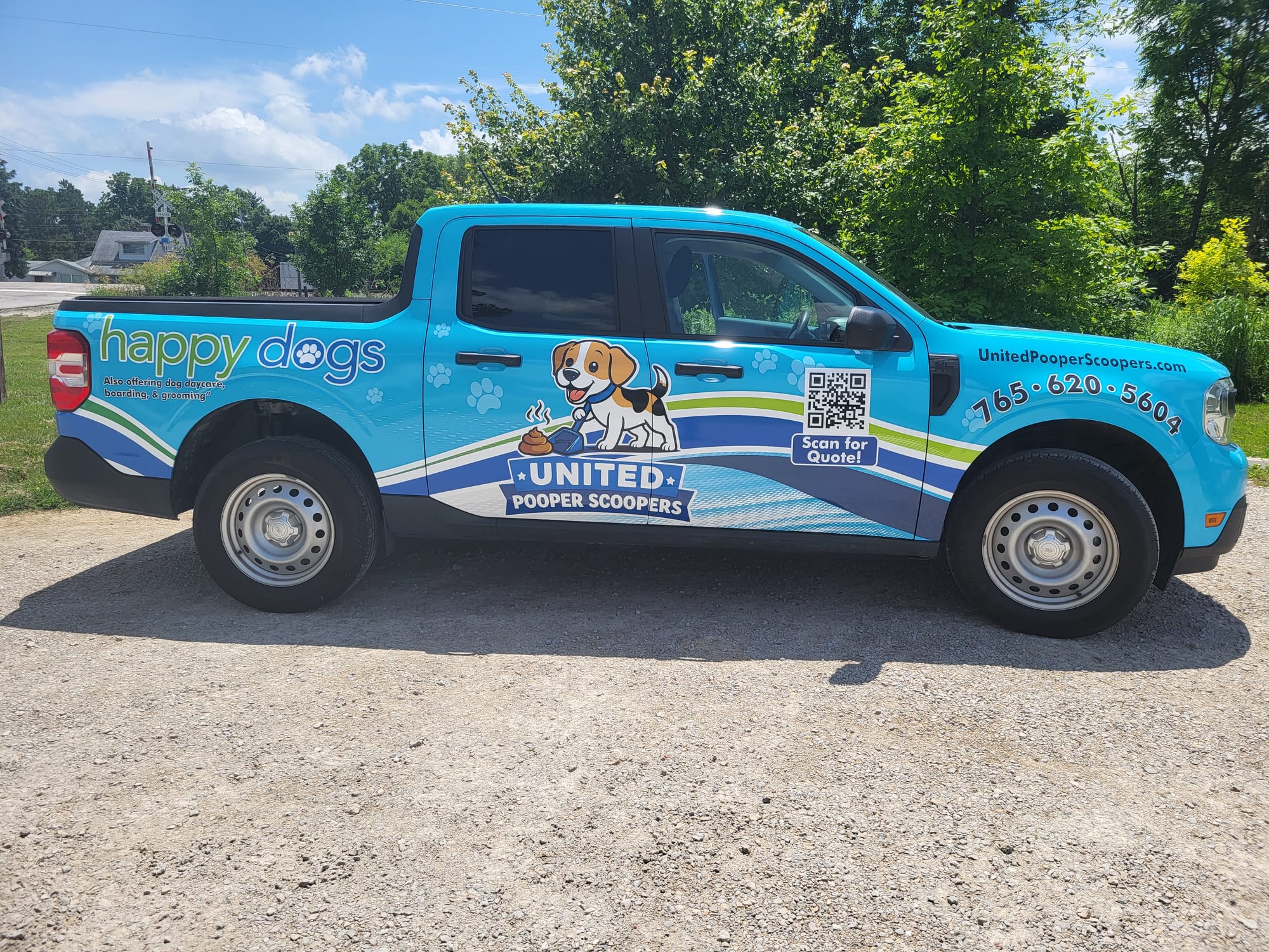 The branded United Pooper Scoopers service truck, driver side
