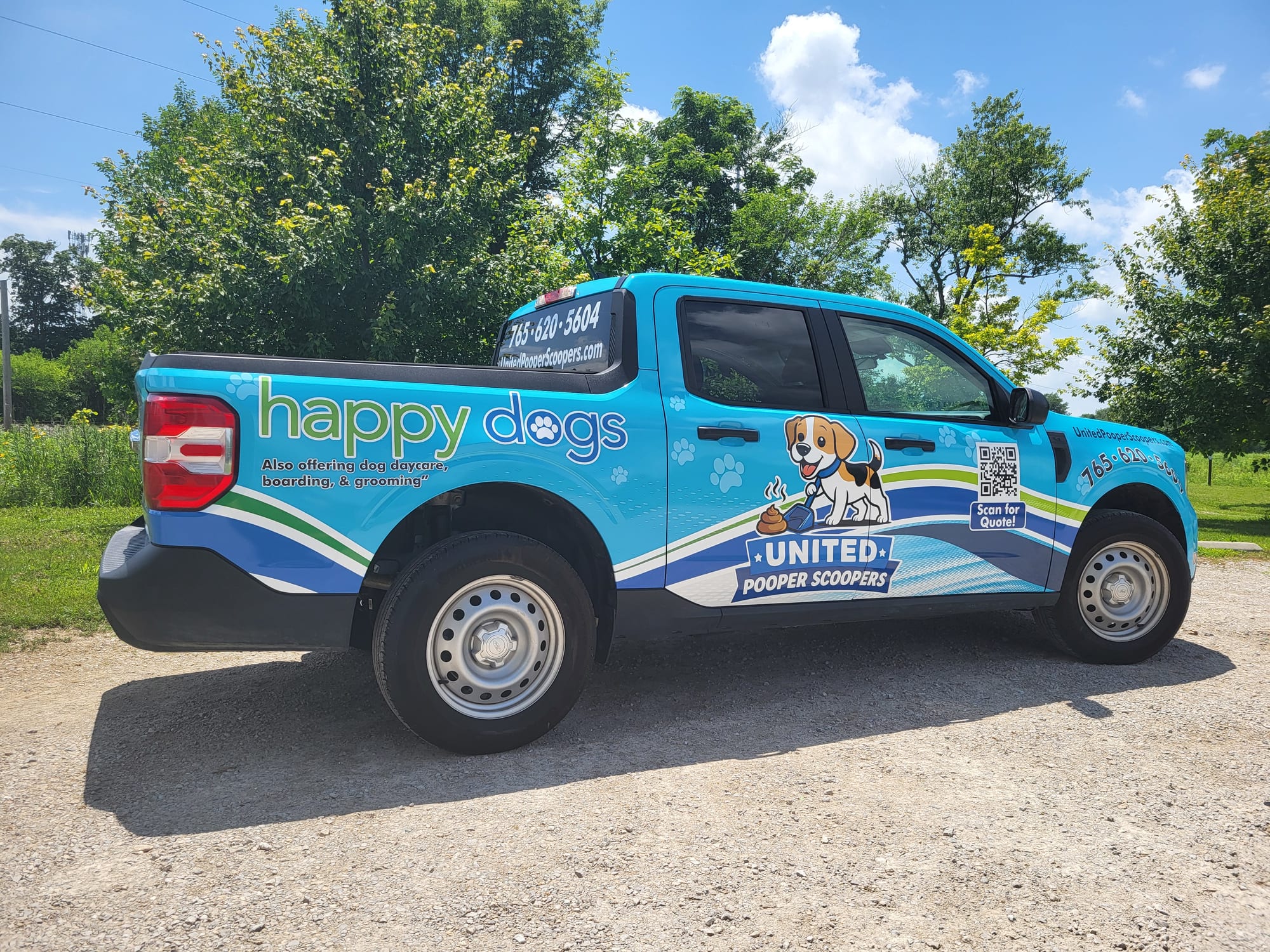 The branded United Pooper Scoopers service truck, seen from the rear quarter
