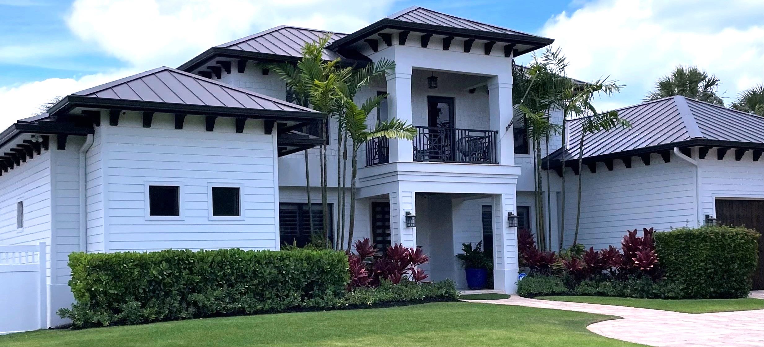 Modern home on the Treasure Coast with a dark standing-seam metal roof