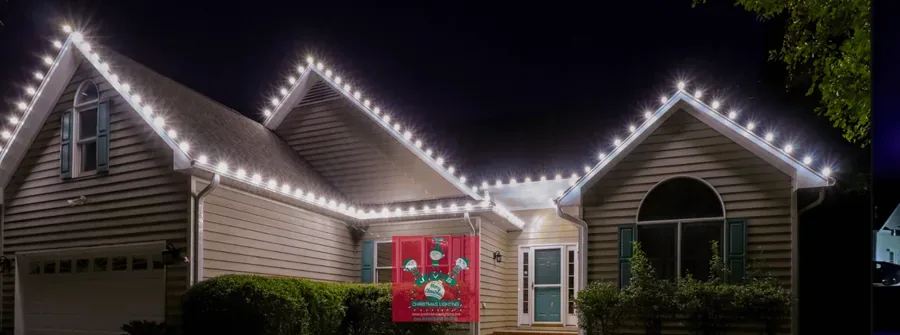 Home lit in cool white Christmas lights
