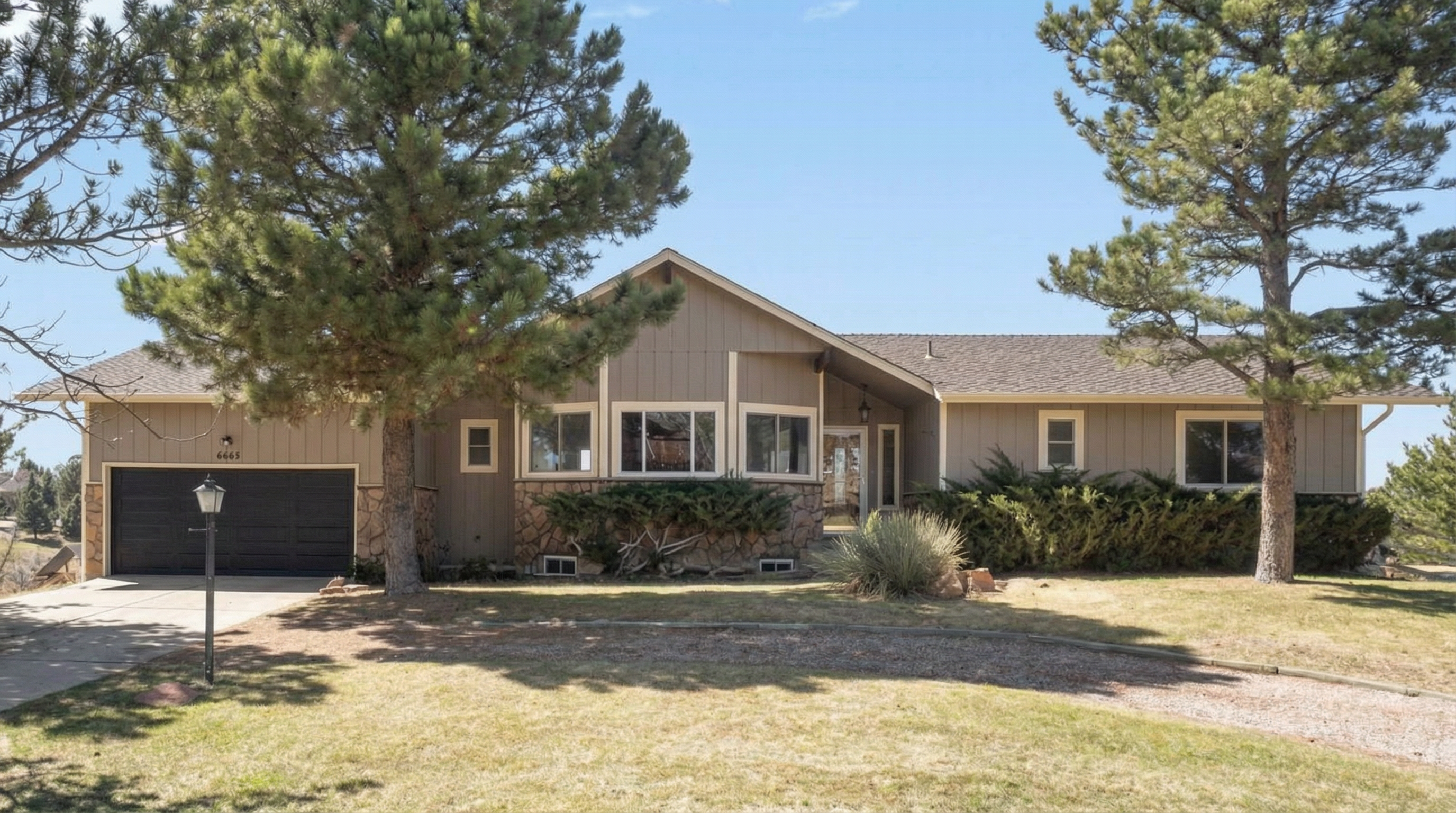Suburban house with brown exterior and stone accents