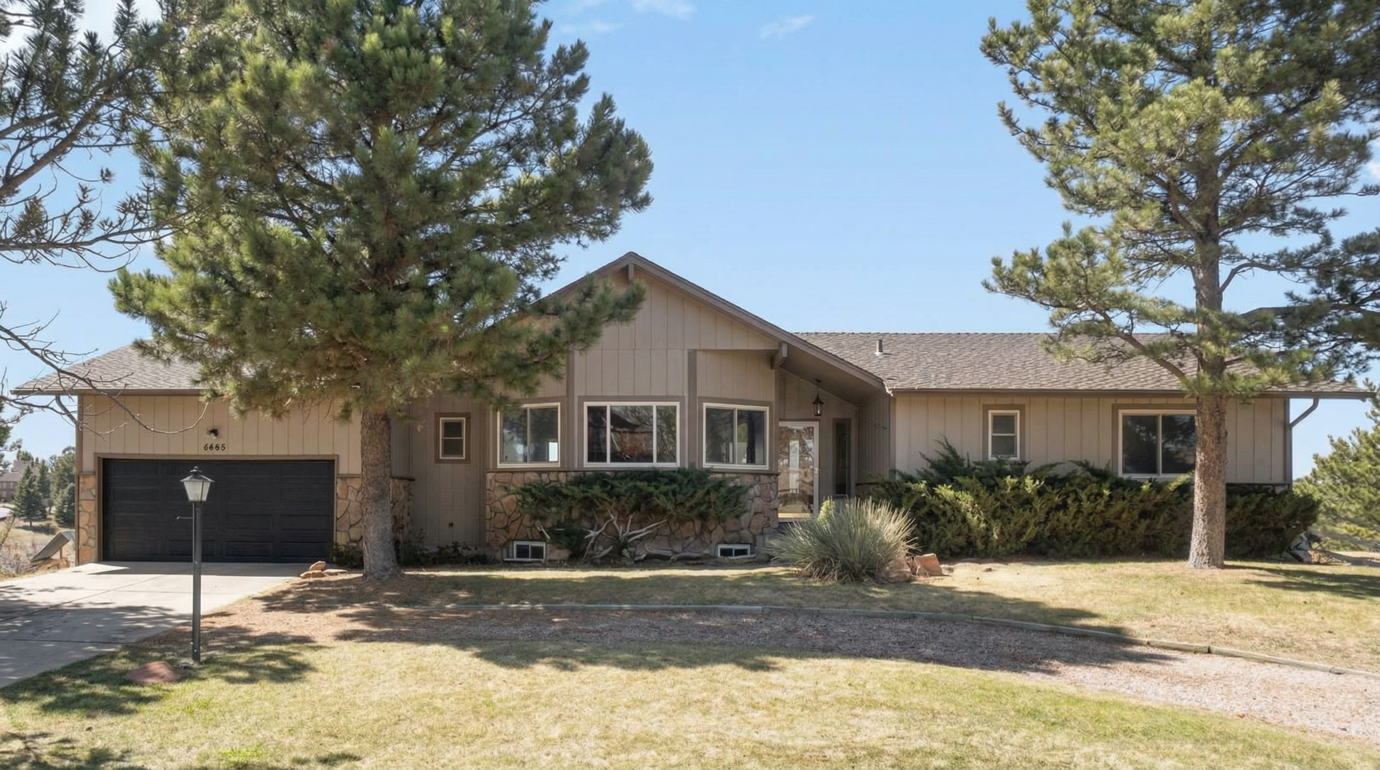Single-story home with stone and wood exterior