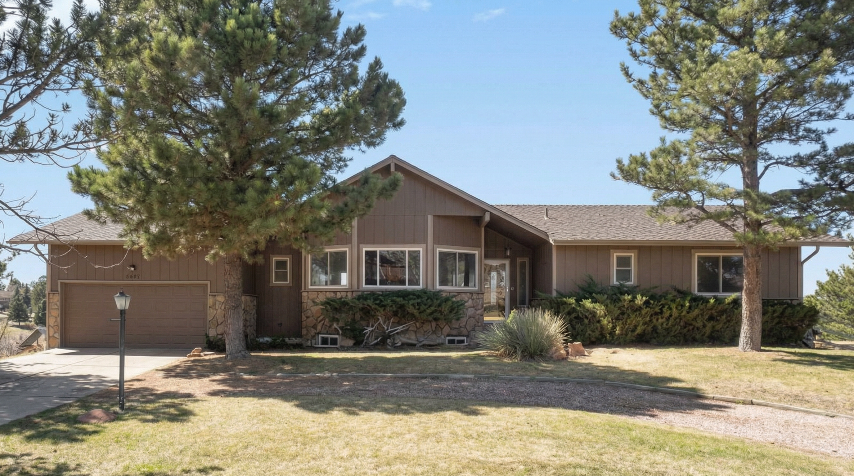Single-story brown house with stone accent facade