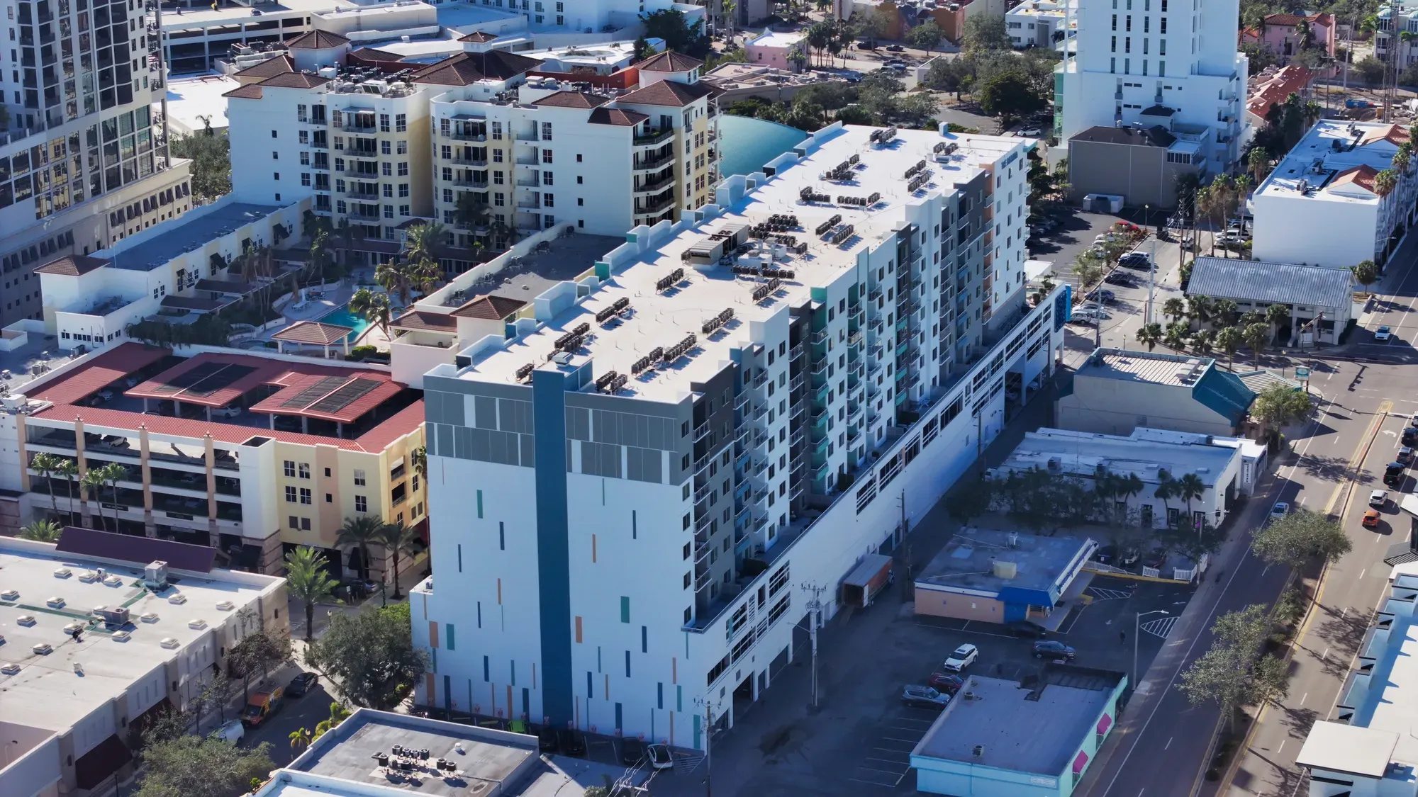 Aerial of The Desota Apartments, a white mid-rise apartment building, in downtown Sarasota.