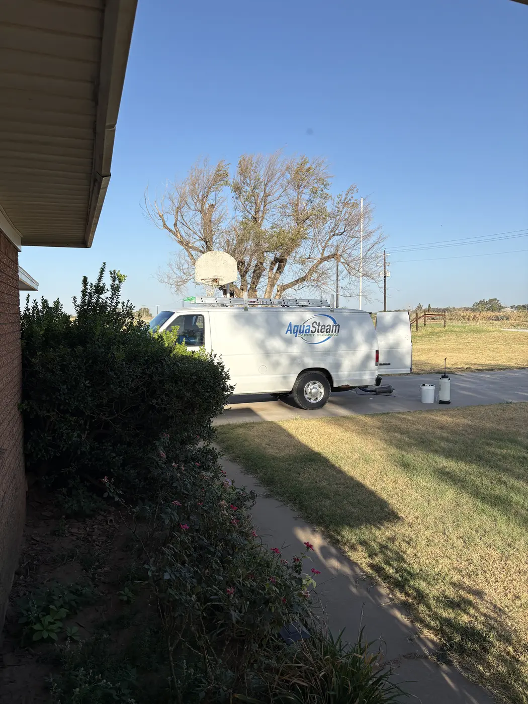 Aqua Steam van parked in the driveway of a home