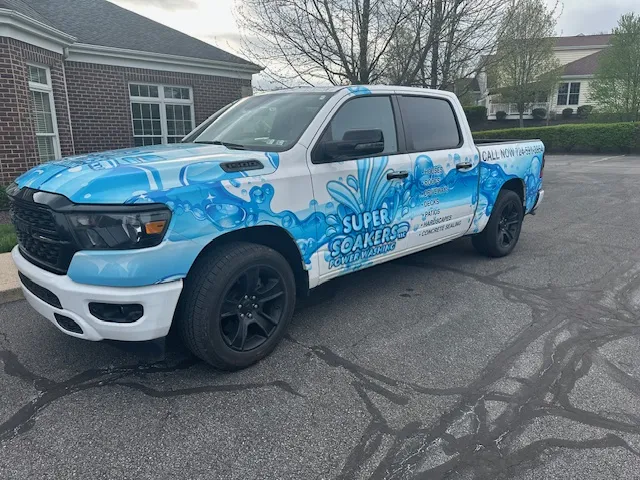 Blue pickup truck branded Super Soakers Power Washing