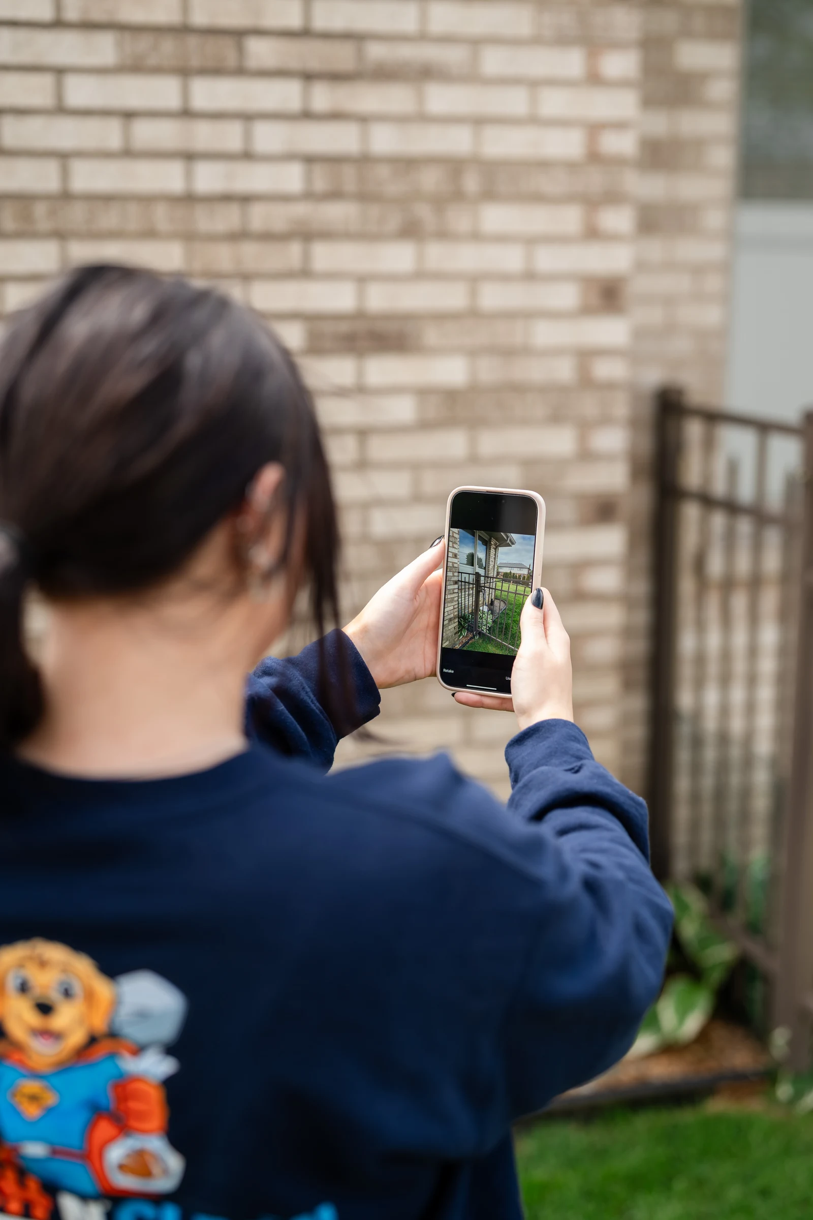 Fetch N Clean team member photographing a backyard after a cleanup.