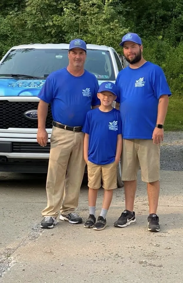 Three members of the Super Soakers family team in matching blue shirts