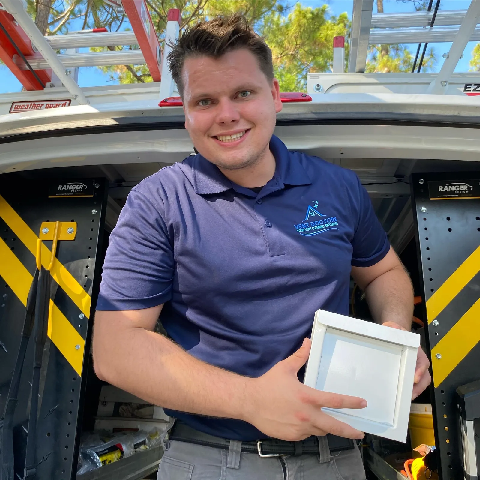 Dryer Vent Doctors technician standing beside service van with professional cleaning equipment
