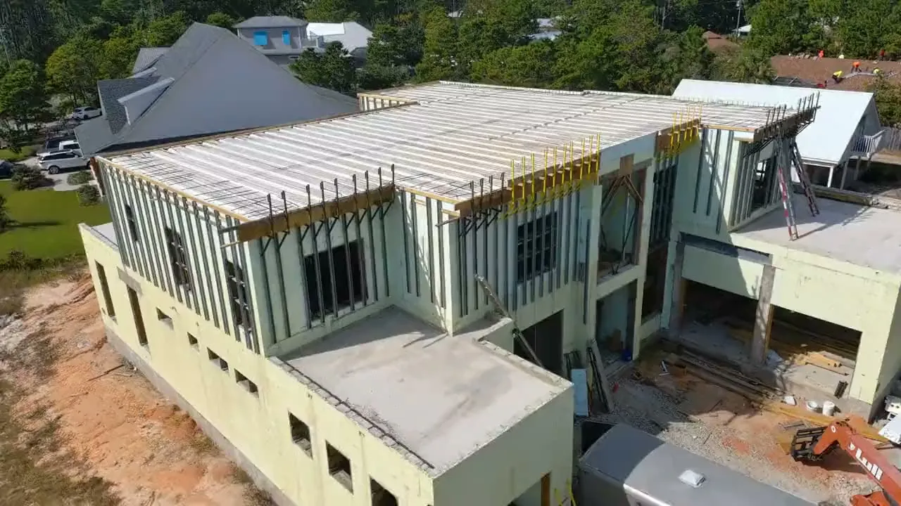 Aerial view of a two-storey ICF house shell with the floor deck formed and bracing in place.