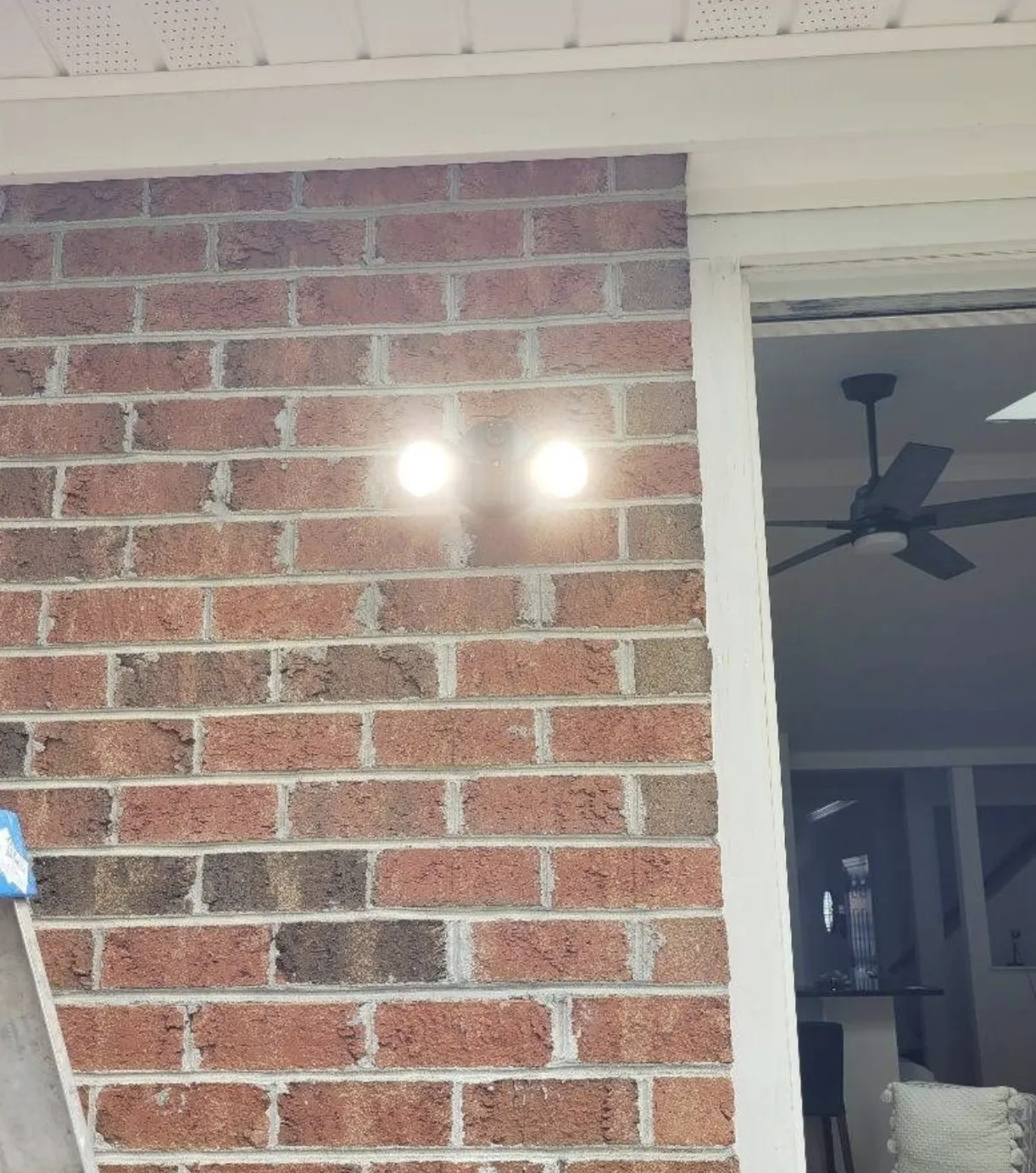 Newly installed outdoor wall light on a brick exterior