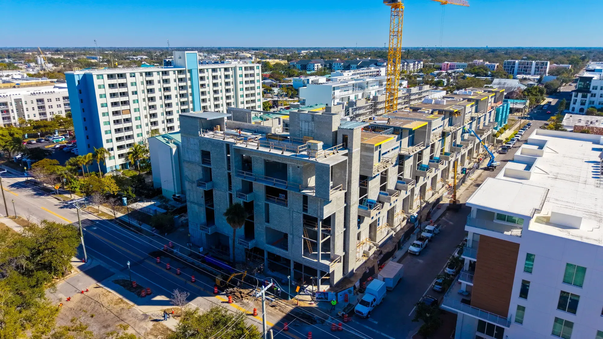 The Gallery under construction, a multi-storey residential building seen from street level with a tower crane behind.
